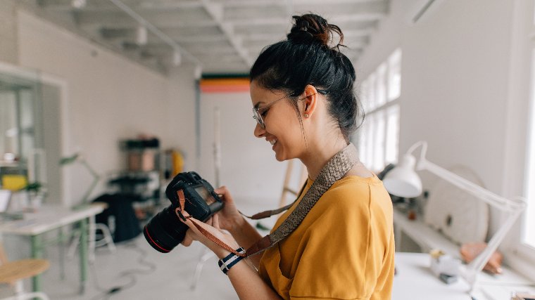 Young female photographer preps for photoshoot.