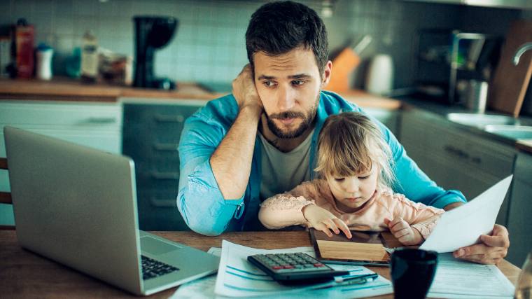 worried father reviewing finances with young daughter