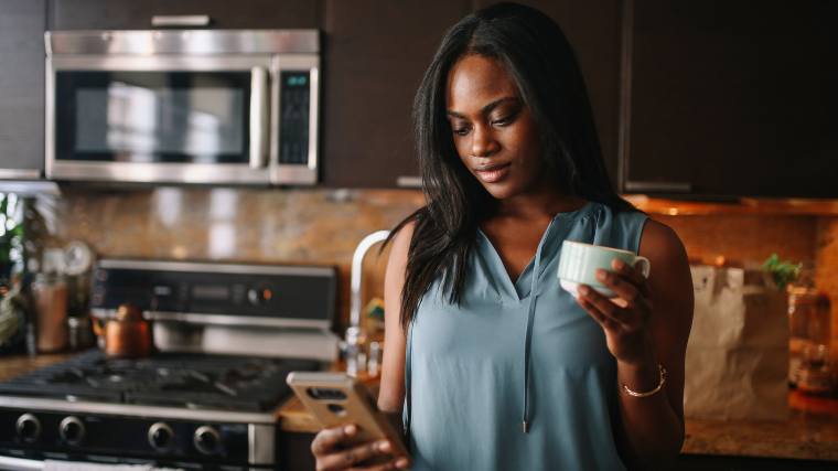 woman at home checking her phone