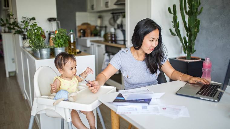 mother working while watching small child