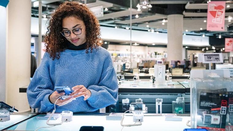 Woman shopping for new phone.