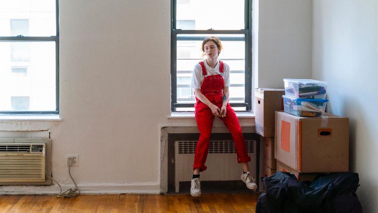 Woman in empty apartment.