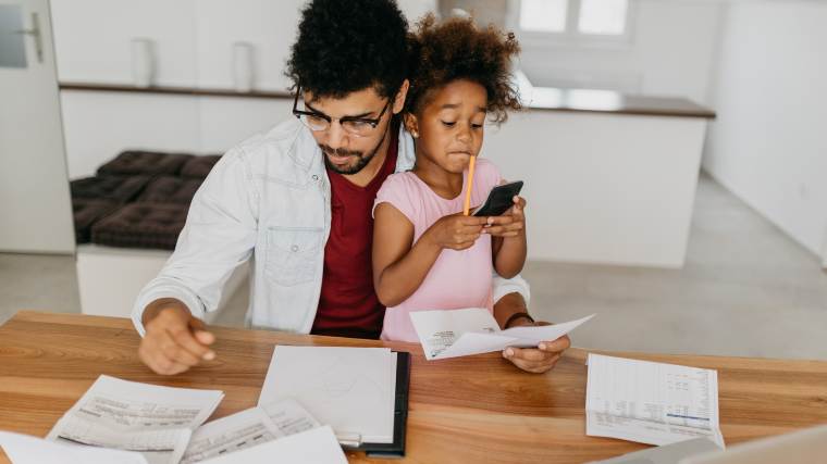 father and daughter reviewing the family bills