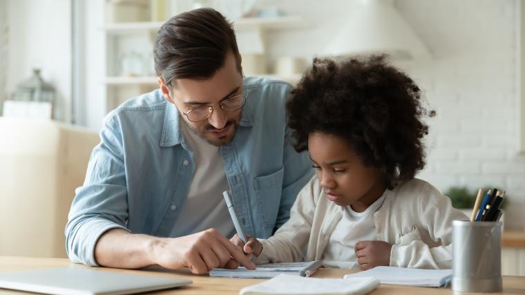 father and daughter doing homework together