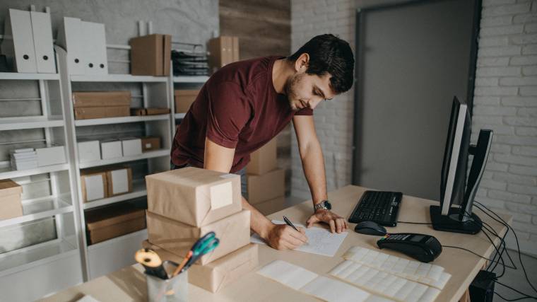 man preparing orders to ship for his online store