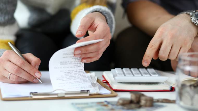 using a calculator and reviewing receipts