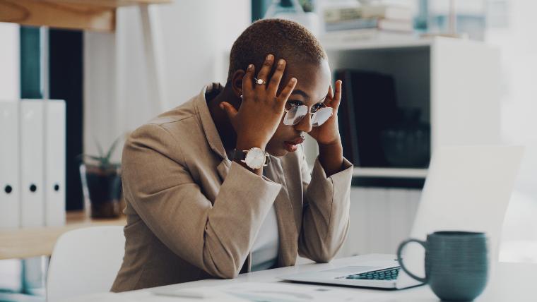 stressed out woman sitting in front of a laptop