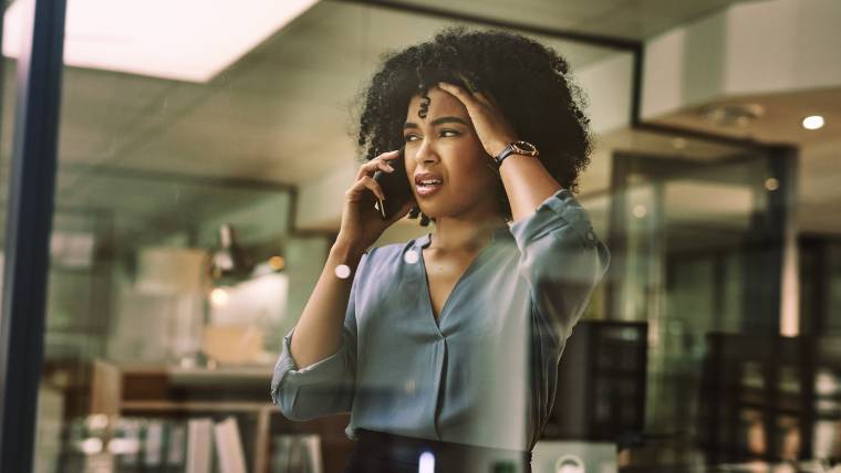 Unhappy woman talking on the phone.