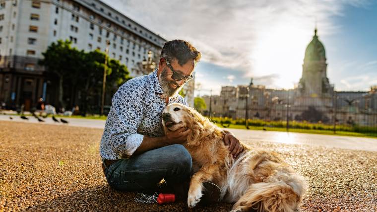 Man sitting outside with his dog.