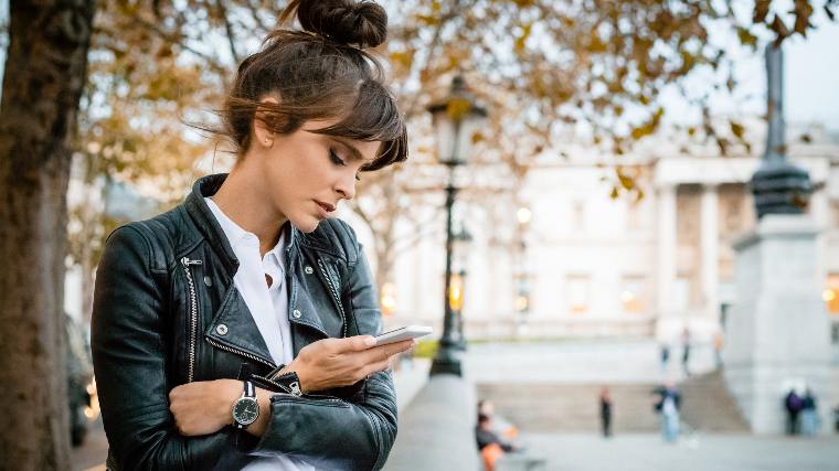 Concerned woman checking phone.