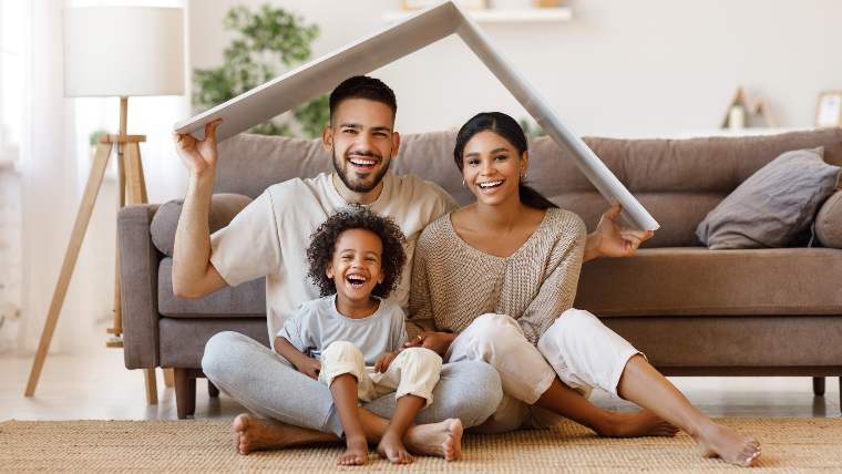 Young family sitting together in their new home.