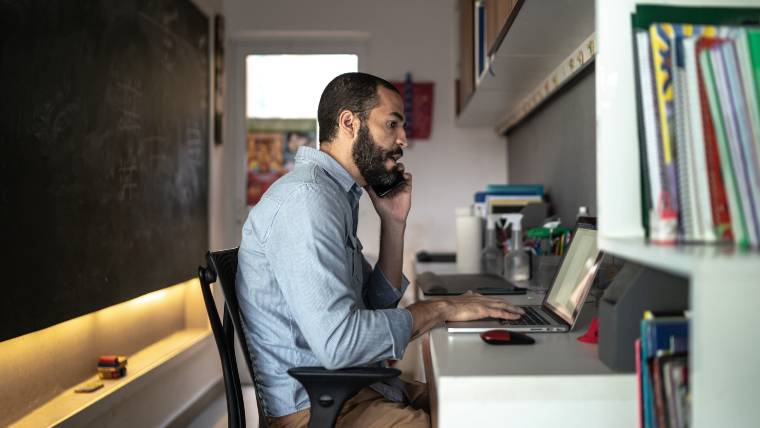 Man on phone negotiating with a creditor.