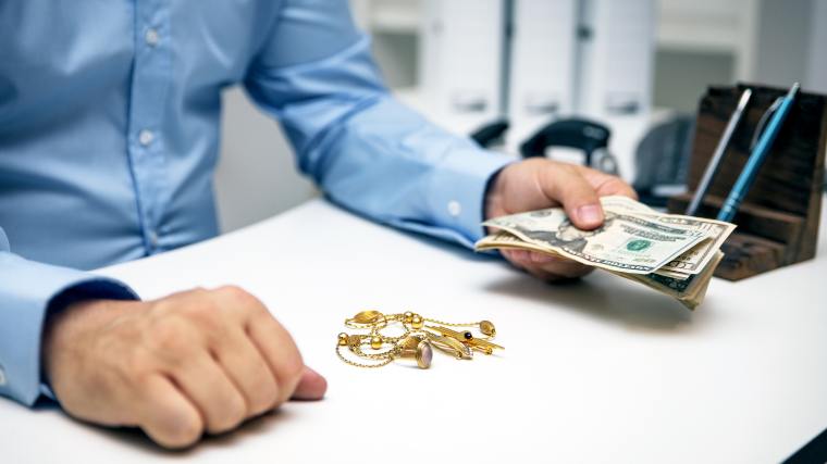 man purchasing jewelry at a pawn shop