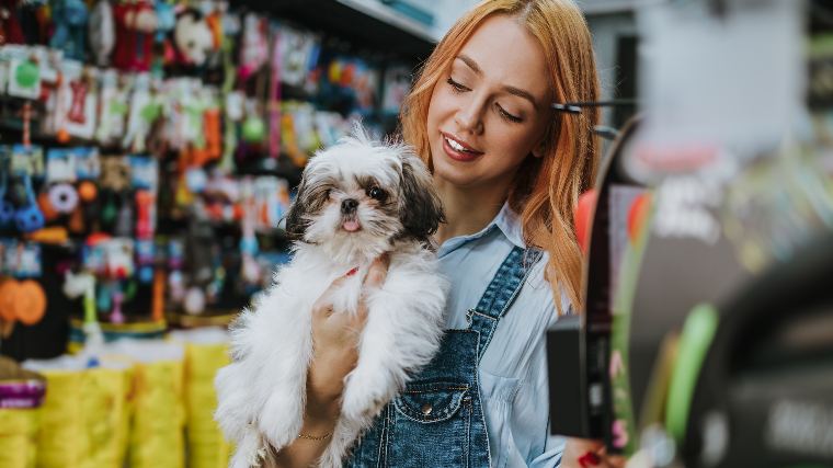 Woman and dog in pet store.