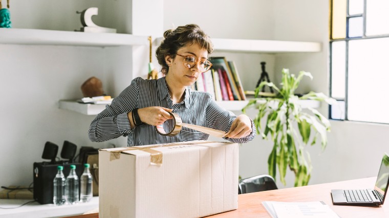 woman packing a box for shipping