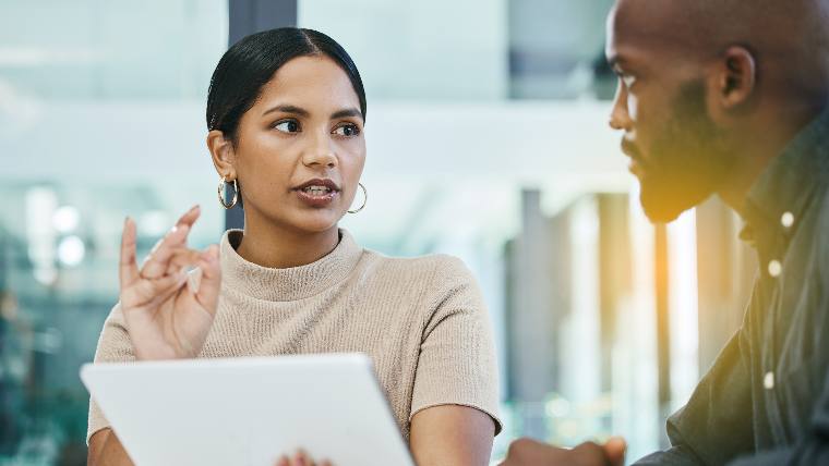 Two employees meeting in professional setting.