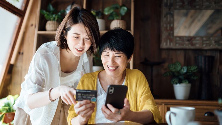 Mother and daughter using credit card.