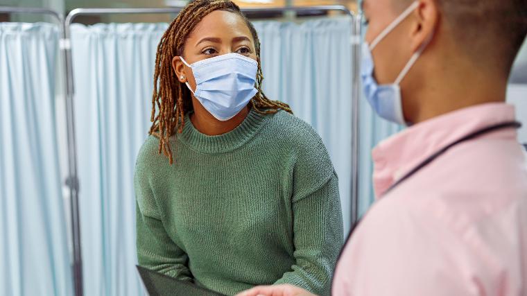 Patient speaking to doctor at the hospital.