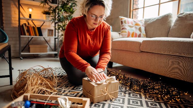 Woman wrapping present.