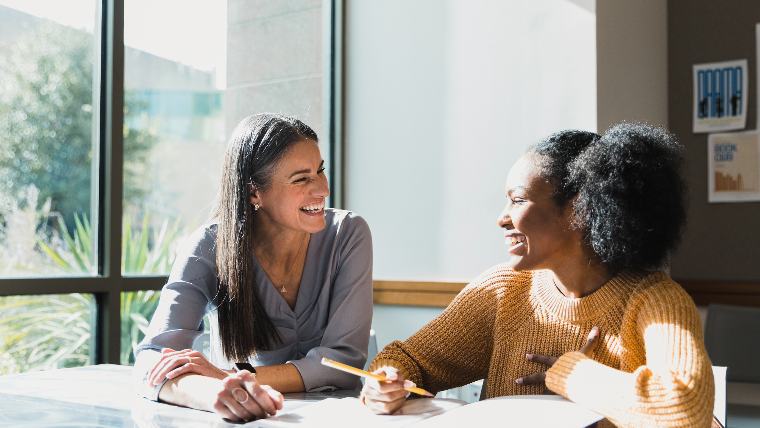 Woman providing counseling to younger woman.