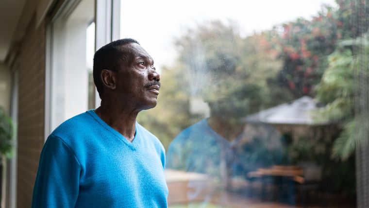 Man looking out window.