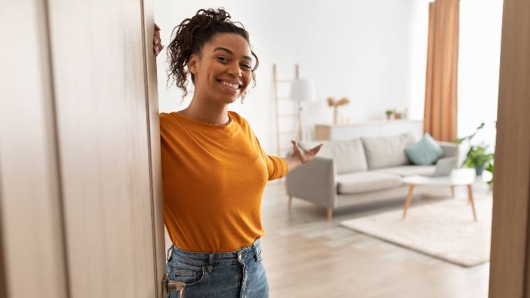 Woman welcoming into home.