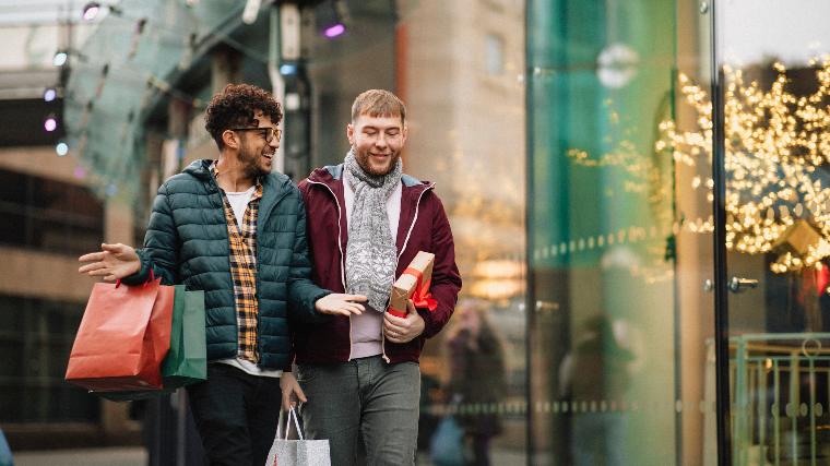 Two young men holiday shopping together.