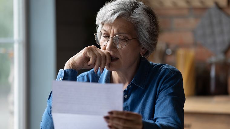 Senior woman reading her mail.