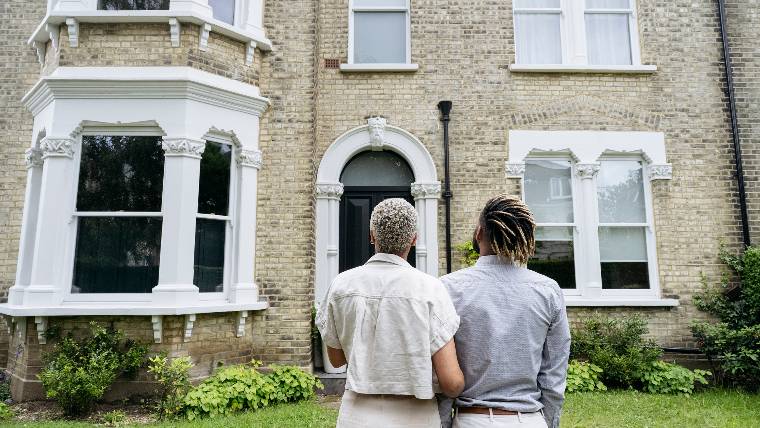 Standing outside family home.