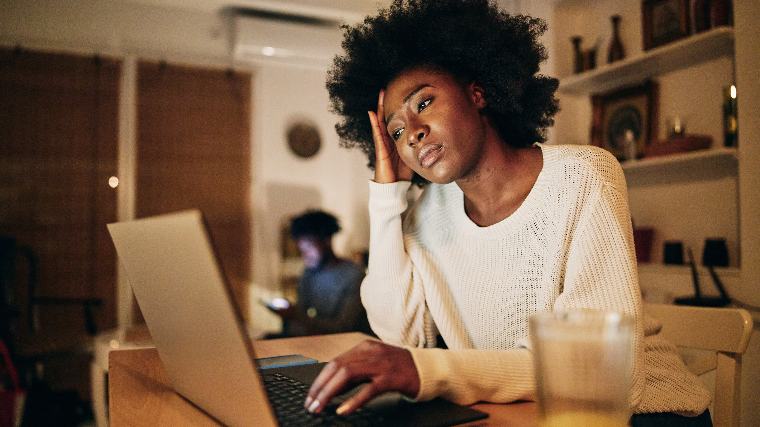 Worried woman using laptop.