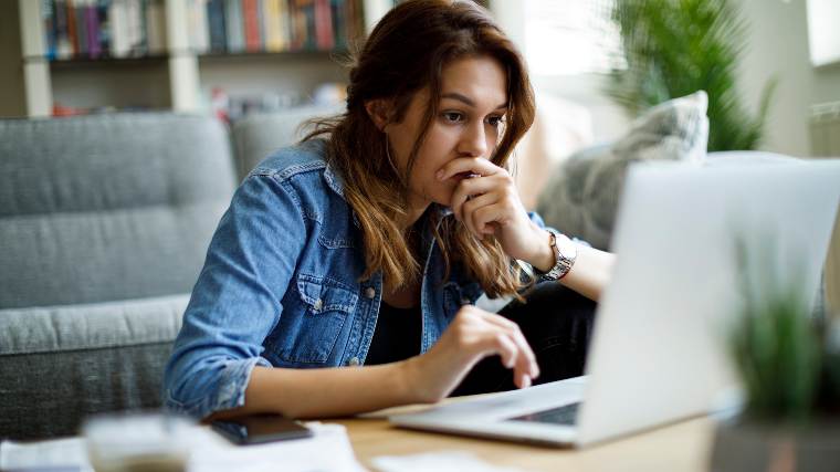 Concerned woman completing her taxes.