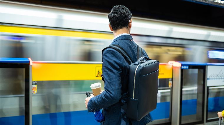 Young man waiting for the train at the subway.