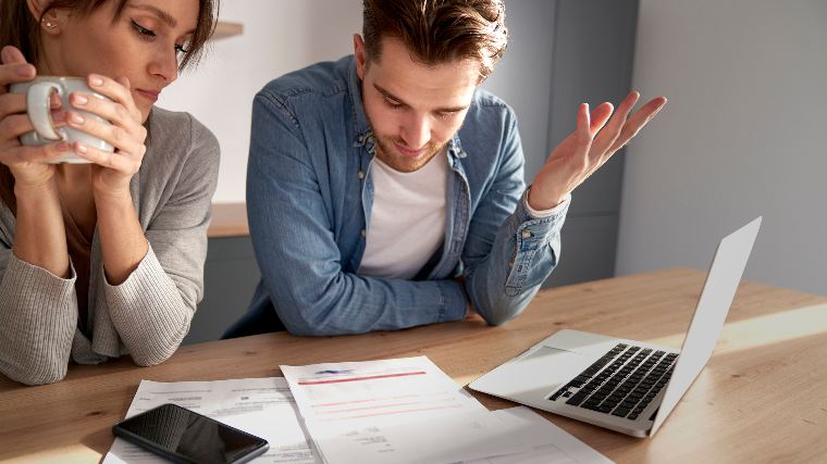 Concerned couple reviewing bills.