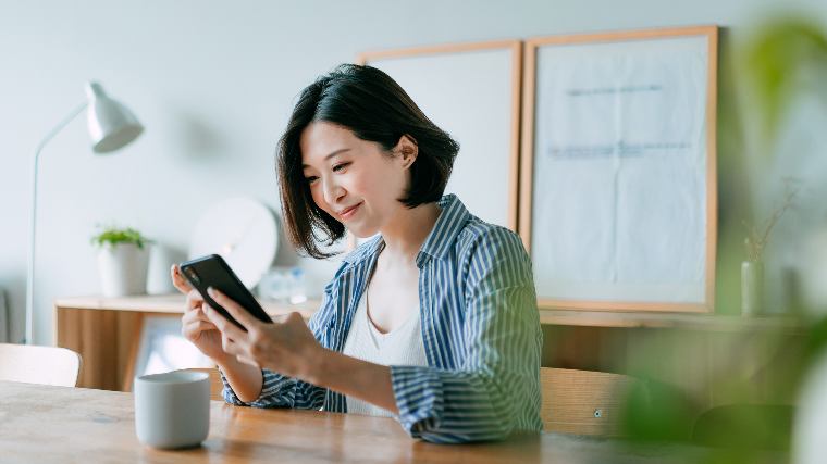 Woman reviewing finances on phone.