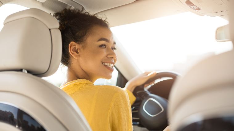 Young woman in new car.