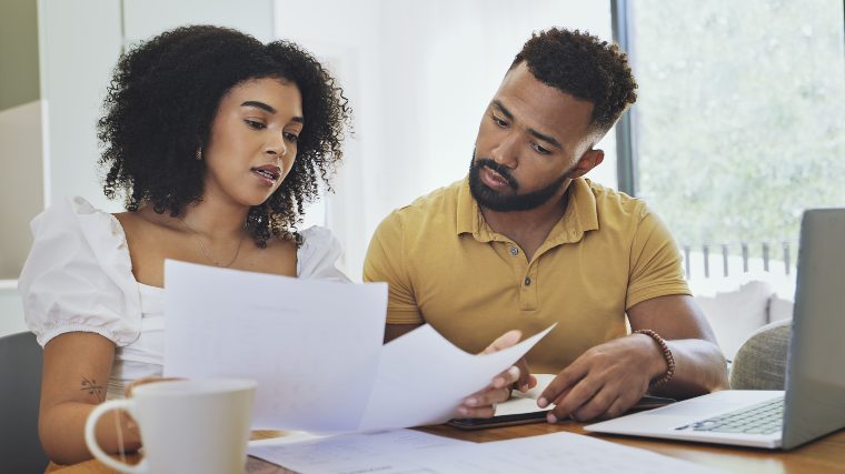 Concerned couple reviewing bills.