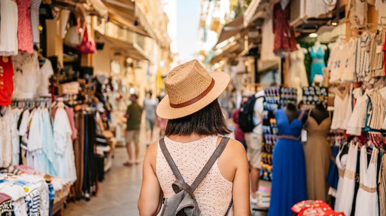 Young woman browsing in open air market.