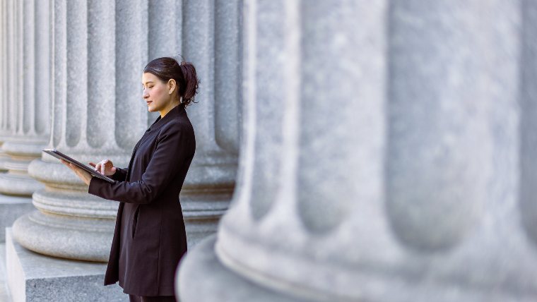 Young lawyer standing outside a courthouse.