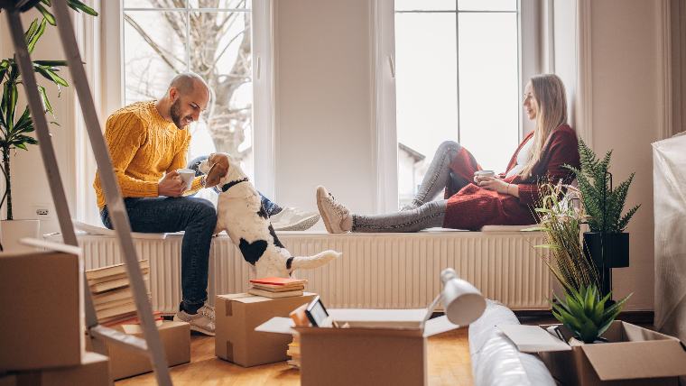 Couple with dog in apartment.