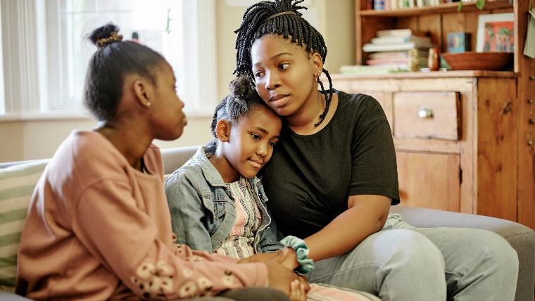 Single parent speaking with two young children.