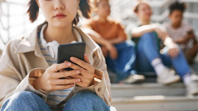 Teenager using smartphone.