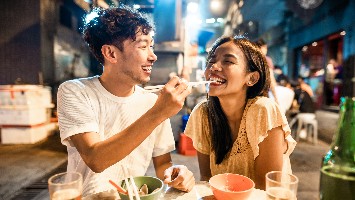 Young couple enjoying dinner out together.