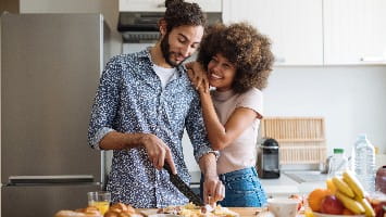 Young couple cooking together in the kitchen.