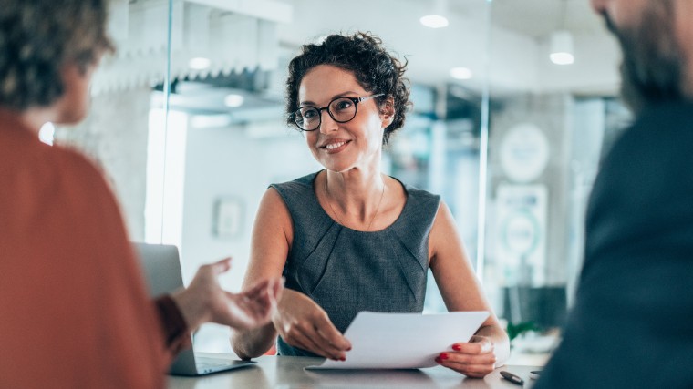 Professional woman consulting with two people.