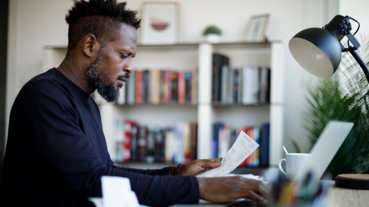 Concerned man reading collection letter.