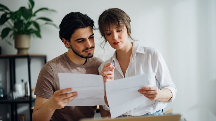 Couple looking at bills together.