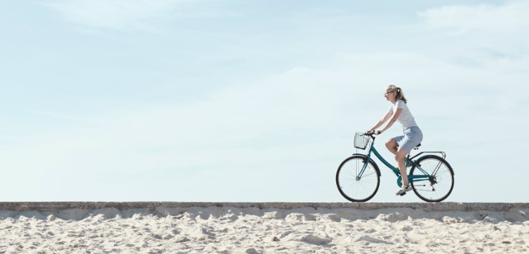 Woman on bike at beach
