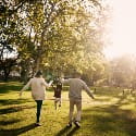 Family walking together in the park on a sunny day.