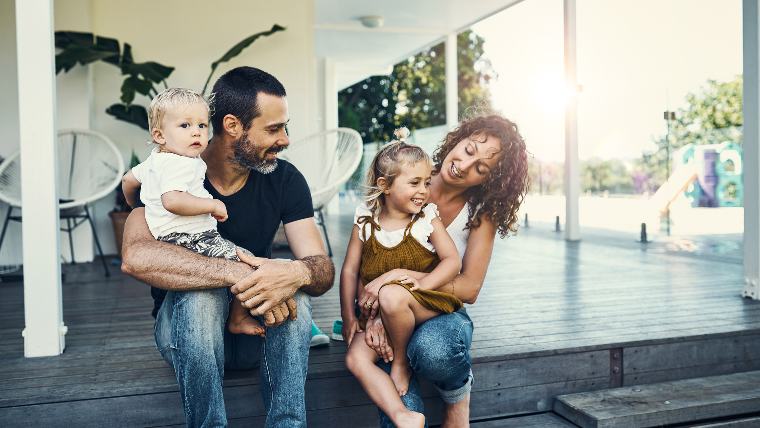 Family sitting together on their porch.