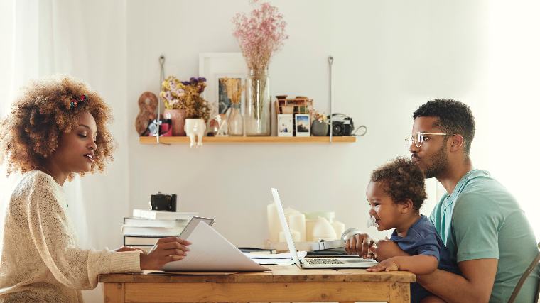 Young family reviewing documents together.